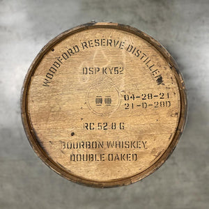 
                  
                    Head of a Woodford Reserve Double Oaked Bourbon barrel with distillery name, number, fill dates and a circle with two barrels inside stamped on the head
                  
                