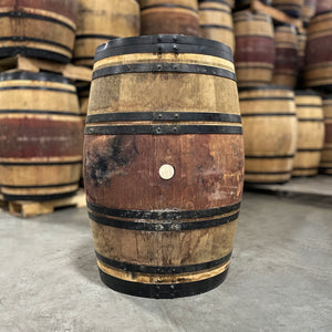 
                  
                    Red, port-stained side and black rings of a Breckenridge Distillery Port Finish Whiskey Barrel with other used port barrels in the background
                  
                