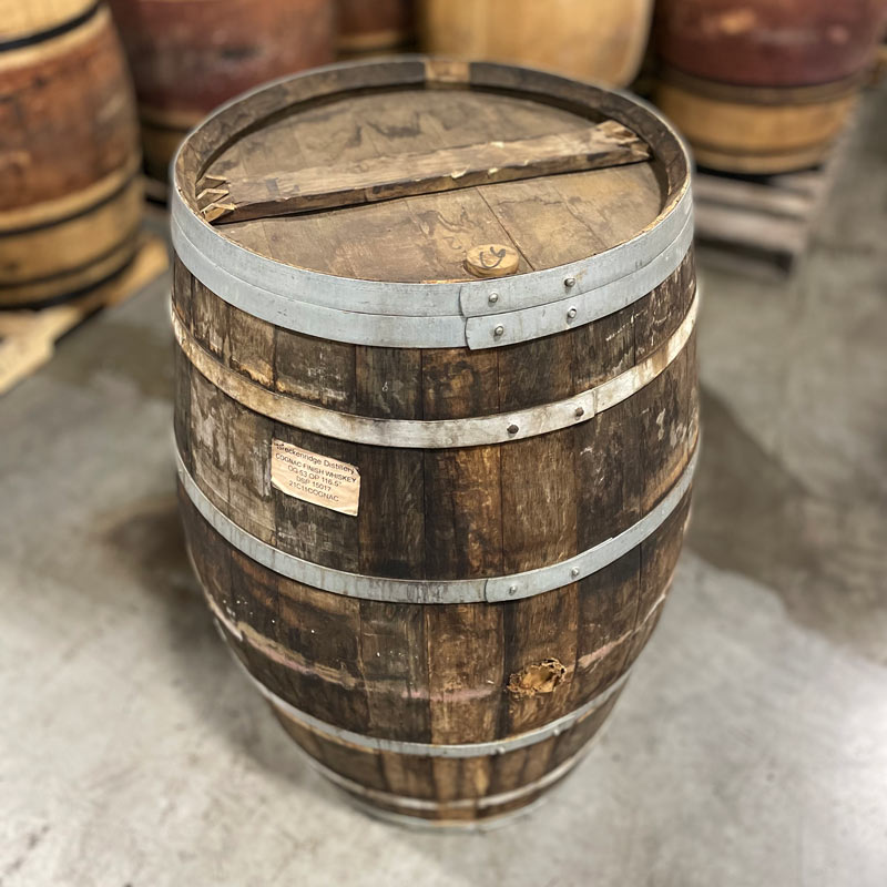 Head and side of a Breckenridge Distillery Cognac Finish Whiskey Barrel with other barrels in the background