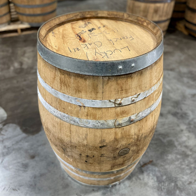 Head and side of a Head of a Lucky Seven Bourbon The Frenchman Cask Finish Barrel with Lucky 7 French Oak 1 and fill date handwritten on the head