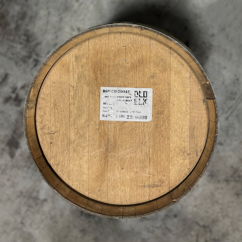 
                  
                    Head of an Old Elk Port Cask Finish Bourbon Barrel with a distillery sticker and information on the head
                  
                