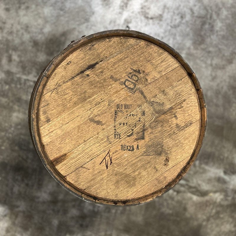 
                  
                    Head of a Woodford Reserve Rye Whiskey Barrel with Old Watermill Brown-Forman markings stamped on the head
                  
                