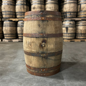 
                  
                    Bunghole side of a French Lick Char 2 Rye Whiskey Barrel with other used whiskey barrels stacked in the background
                  
                