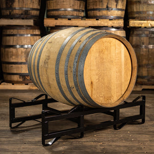 
                  
                    220 liter Oloroso sherry cask on a rack with barrels stacked on pallets in the background
                  
                
