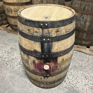 
                  
                    Side and head of an Arrington Vineyards Red Wine Bourbon Barrel with other used barrels in the background
                  
                