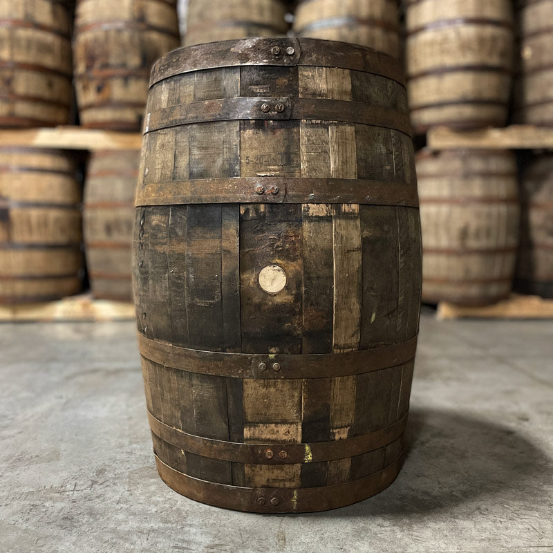 bung side of a grape brandy barrel (ex-whiskey) with other used whiskey barrels in the background