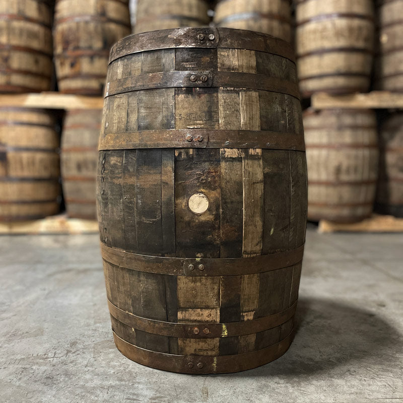 
                  
                    bung side of a grape brandy barrel (ex-whiskey) with other used whiskey barrels in the background
                  
                