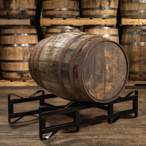 
                  
                    Barbados rum barrel ex bourbon on a rack with barrels stacked on pallets in the background
                  
                