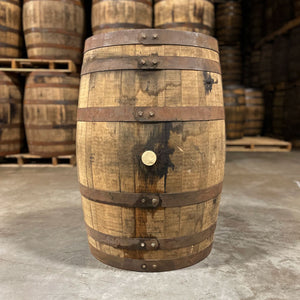 
                  
                    Side of a Laird's Apple Brandy Barrel with used whiskey barrels stacked on pallets in the back
                  
                