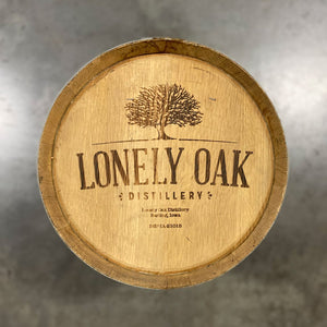 
                  
                    Head of a 10 Gallon Lonely Oak Rum Barrel with tree and Lonely Oak Distillery Earling, Iowa engraved on head
                  
                