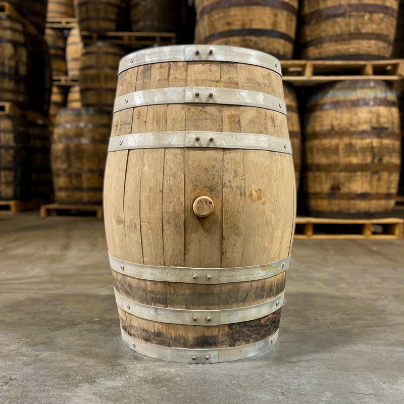 Side of a 15 Gallon Lonely Oak Rum Barrel Ex-Bourbon with other used barrels on pallets in the background