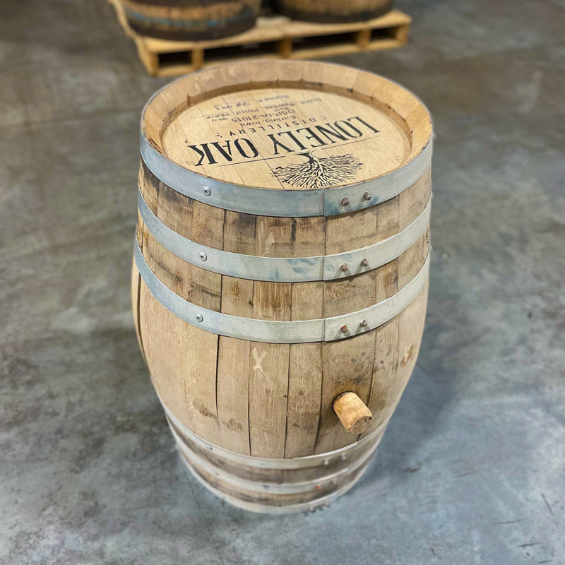 
                  
                    Side and head of a 15 Gallon Lonely Oak Rum Barrel Ex-Bourbon with tree and Lonely Oak Distillery logo and distillery information stamped on the head
                  
                