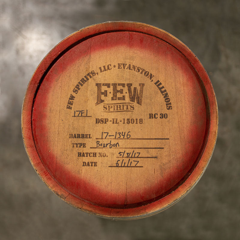 Head of a 30 Gallon FEW Spirits barrel with red paint along the outer border of the head and distillery logo and information stamped on the head