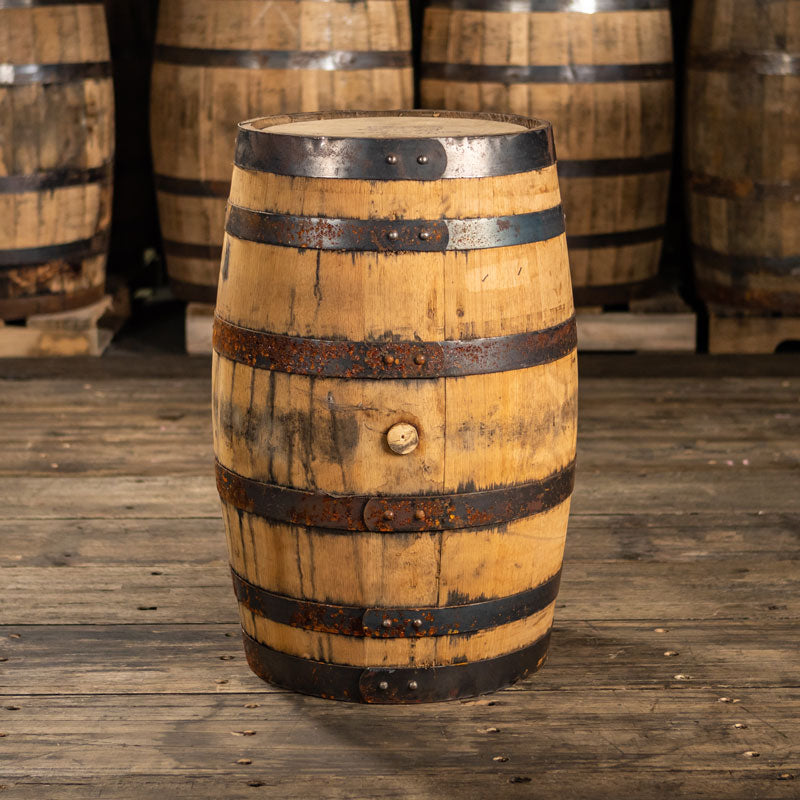 25 Gallon FEW Spirits 4 Grain Bourbon barrel with rusted rings and stained light colored staves