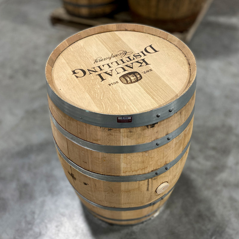 View of head and side of a 30 Gallon Kauai Distilling Co. Bourbon Barrel with Kauai Distilling Company, a barrel image and est 2014 stamped on the head