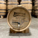 Head of a 5 Gallon Journeyman Whiskey Barrel with spigot on a stand and distillery information stamped on the head.  
