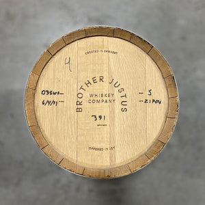 
                  
                    Head of a Brother Justice Single Malt Whiskey barrel with Brother Justus Whiskey Company, Crafted in Earnest Offered in Joy engraved on the head and handwritten whiskey info
                  
                