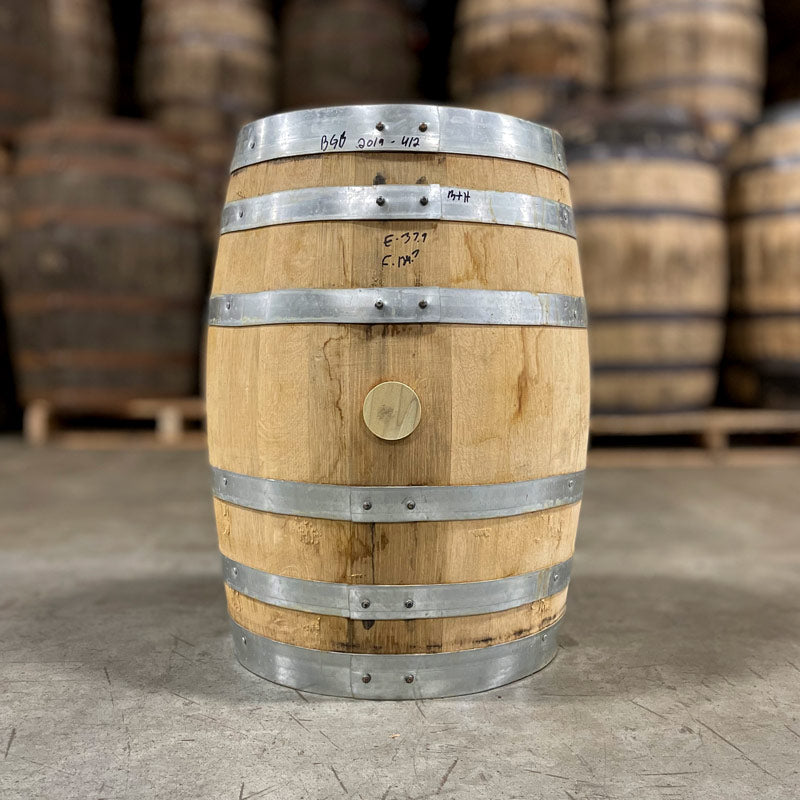 
                  
                    Side of a 10 Gallon Distillery 291 Bad Guy Bourbon Barrel with other used barrels on pallets in the background
                  
                