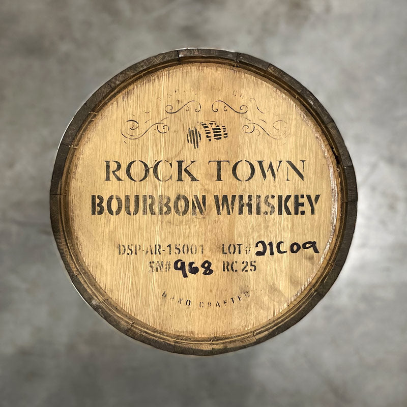 Head of a 25 Gallon Rock Town Distillery Bourbon Whiskey Barrel with  decorative barrel design, distillery information and barrel age on the head.