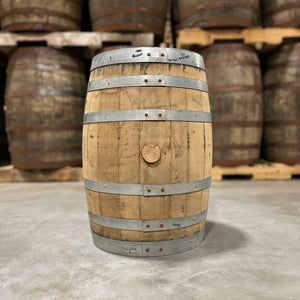 
                  
                    Side and bung of a 15 Gallon Re:Find Distillery Whiskey Barrel and full size used barrels in the background
                  
                