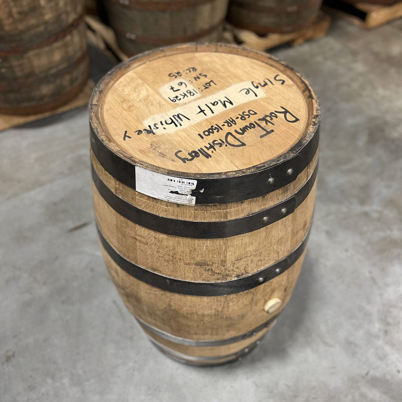 Head and side with bung of a 25 Gallon Rock Town Distillery Single Malt Whiskey Barrel with handwritten distillery information and barrel notes on the head