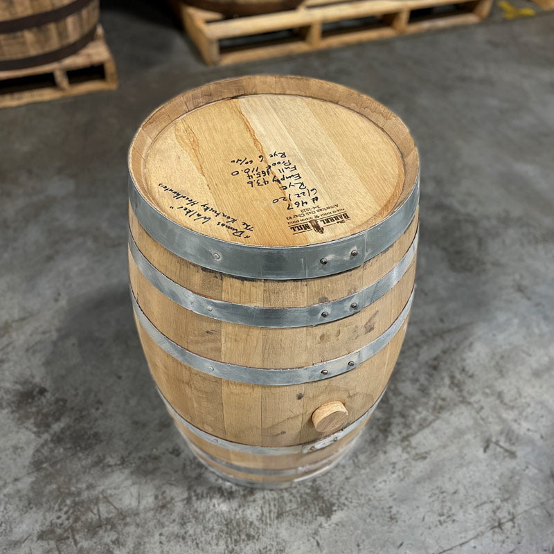 
                  
                    Head and side with bung of a 15 Gallon Lonely Oak Rye Whiskey Barrel with barrels on pallets in the background
                  
                