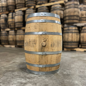 
                  
                    Side with bung of a 30 Gallon West Fork Wheated Bourbon Barrel with other used barrels in the background
                  
                