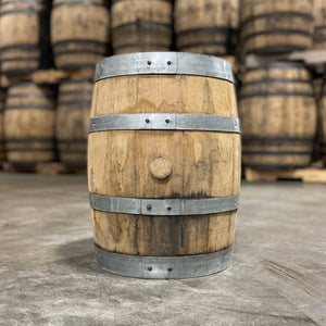 
                  
                    Side with bung of a 5 Gallon Journeyman Honey Barrel with other used barrels stacked in the background
                  
                