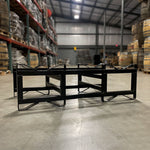 black refurbished 25-30 gallon double barrel steel rack in a barrel warehouse