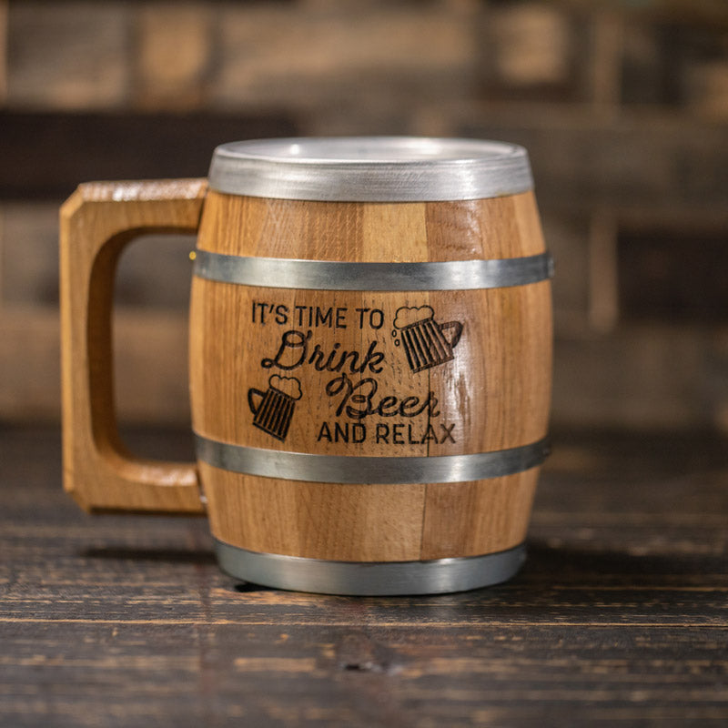 Barrel shaped wood mug with steel rings and wood handle and graphic of two glass mugs full of frothy beer and text It's Time To Drink Beer And Relax