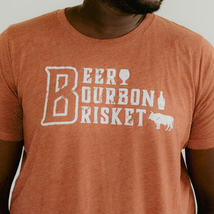 
                  
                    burnt orange t-shirt with Beer Bourbon Brisket and beer glass, bourbon bottle and bull on front of the shirt
                  
                