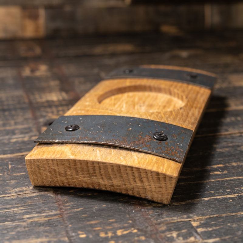 whiskey barrel stave candle holder with circle cut into the middle to hold a candle and steel bands on either side