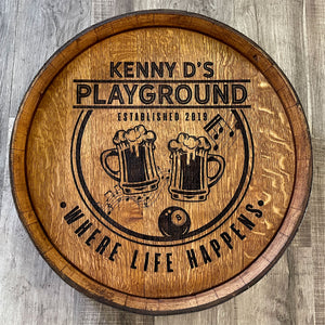 
                  
                    An example of a custom design whiskey barrel head Kenny D's Playground Established 2019 Where Life Happens and two beer mugs with foam flowing over, music notes and an 8 ball
                  
                