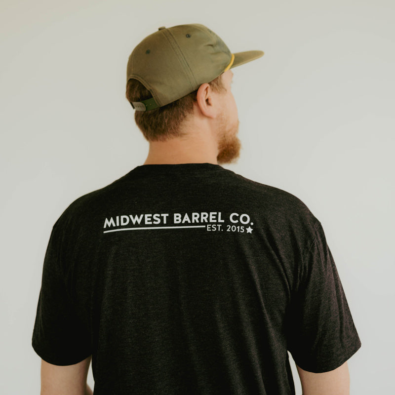 Back of charcoal gray drink craft not crap t-shirt with Midwest Barrel Co. Est. 2015 logo