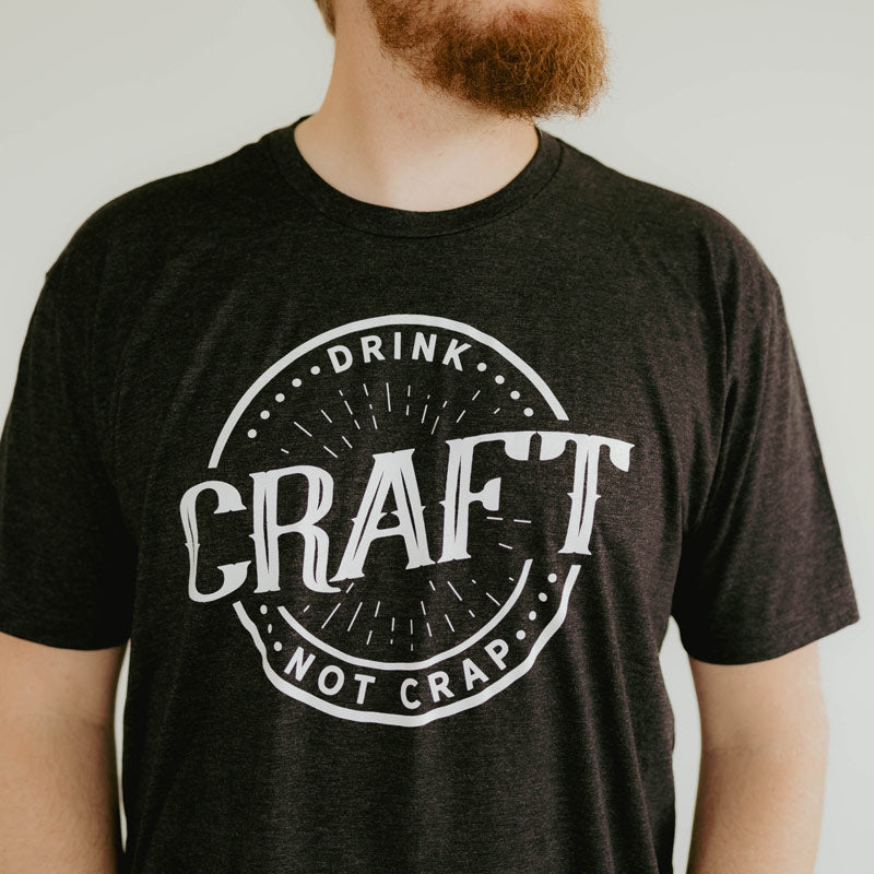 
                  
                    charcoal gray t-shirt with circle design that says drink craft not crap
                  
                
