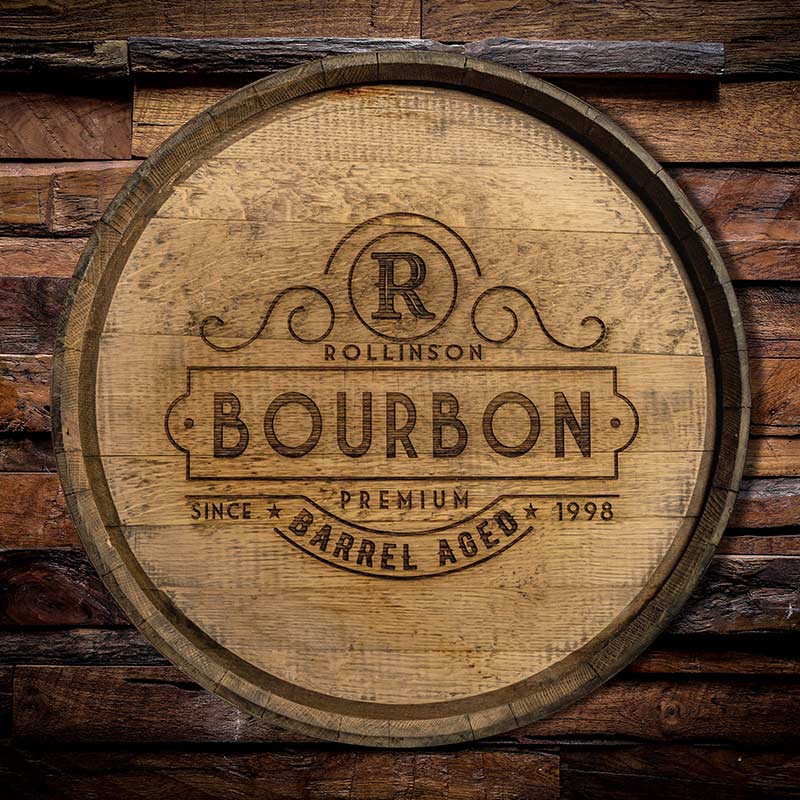
                  
                    Bourbon barrel head hanging on a wood wall and engraved with R Rollison Premium Barrel-Aged Bourbon Since 1998
                  
                