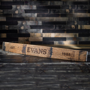 
                  
                    Full size engraved whiskey barrel stave with band marks and Evans in center, Est. on the left end stave and 1985 on the right end
                  
                