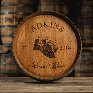
                  
                    Engraved wine barrel with Adkins Wine Bar Est. 2018 and an image of grapes on the vine
                  
                