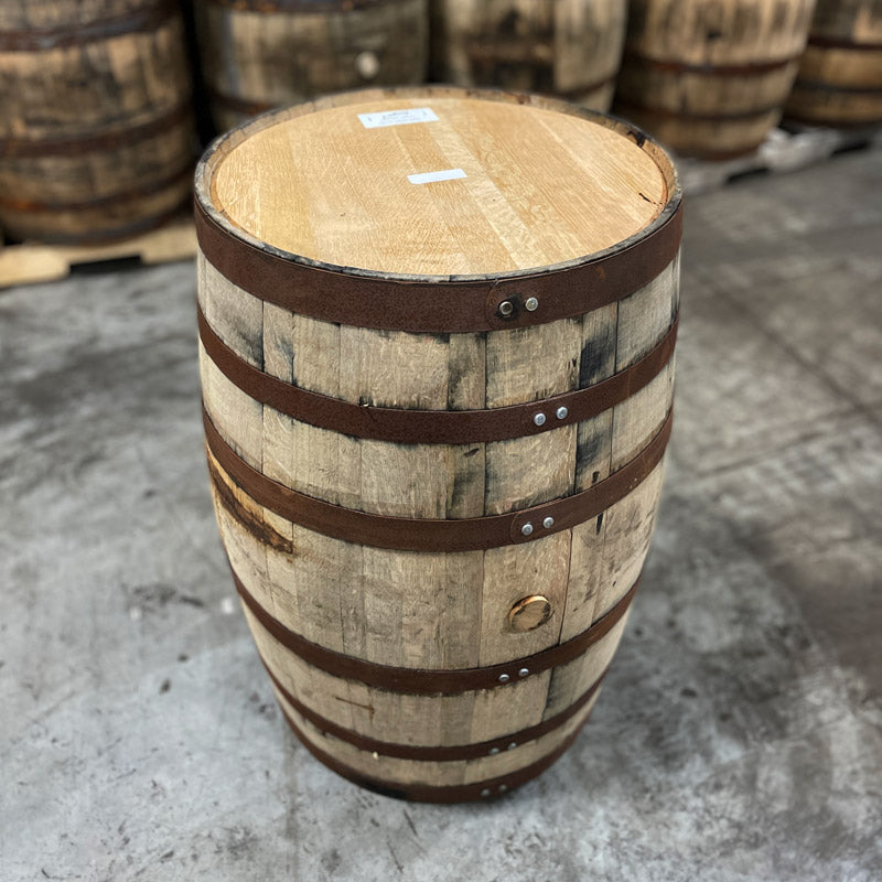 Head and side of a Hangar 1 Grape Brandy Barrel (Ex-Whiskey) with other used whiskey barrels in the background