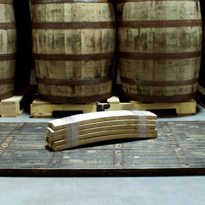 
                  
                    Plastic wrapped bundle of barrel stave firewood on floor in front of barrels on pallets
                  
                