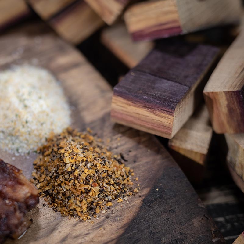 
                  
                    Closeup of Port Cask Bourbon Smoking Wood Chunks, salt and a BBQ rub
                  
                
