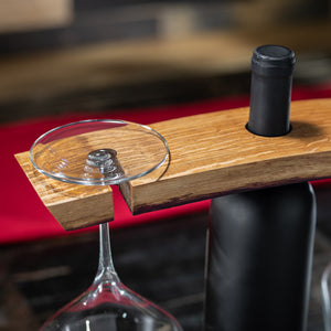 
                  
                    View of red wine barrel stave holder with bottle in center and a glass on one end
                  
                