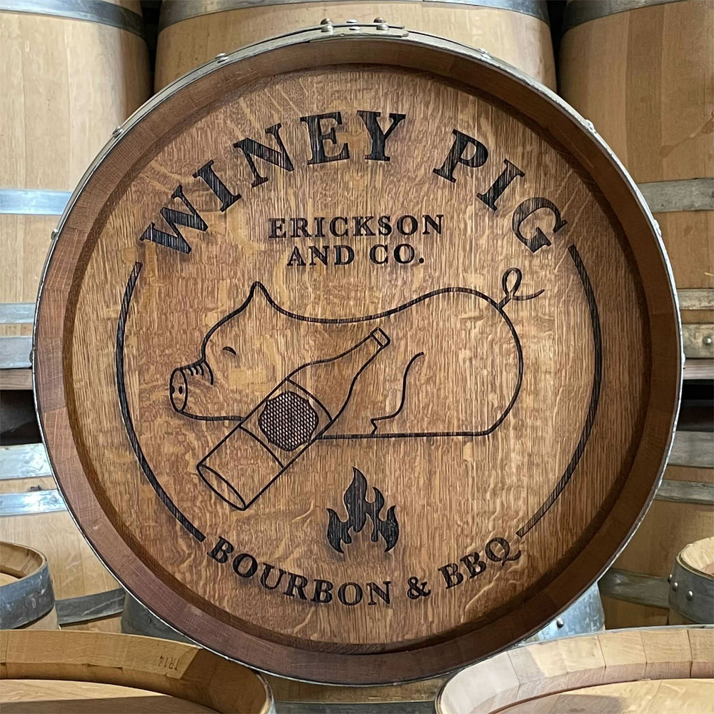 
                  
                    Laser engraved wine barrel head for Erickson and Co. Winey Pig Bourbon & BBQ with a pig and bourbon bottle design
                  
                