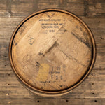 Looking down at head of Jack Daniels whiskey barrel with distillery markings on head