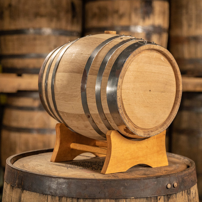 
                  
                    Brand new 5 gallon white oak barrel on a stand placed on top of a barrel
                  
                